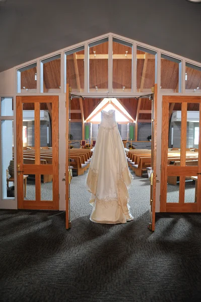 Wedding Dress Hanging Up in a Church