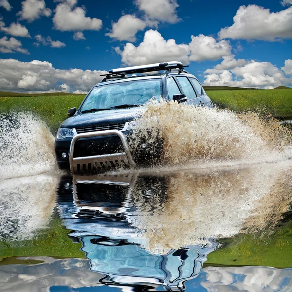 Suv splash on the river outdoor ,traveling on the road.