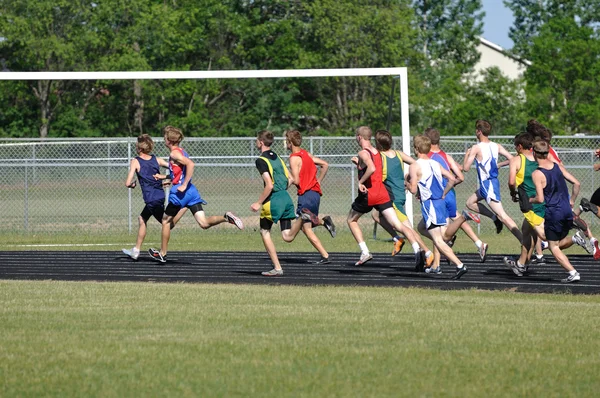 Teen Boys Running in a Long Distance High School Track Meet Race