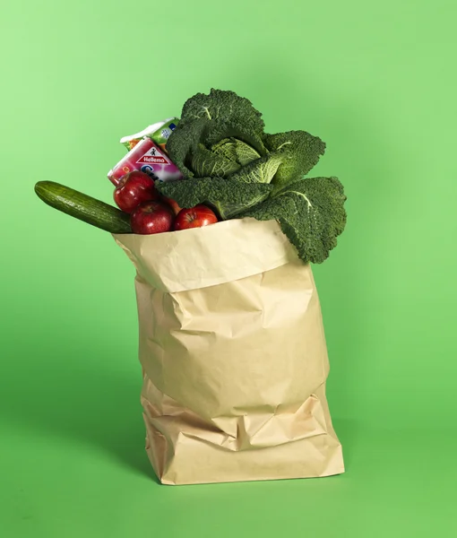 Paper bag with food on a green background