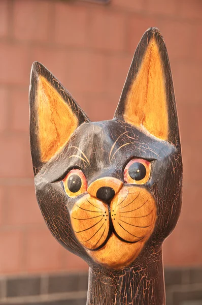 Portrait of wooden hand painted cat statuette