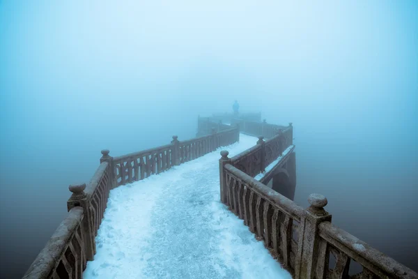 Zigzag bridge in winter fog