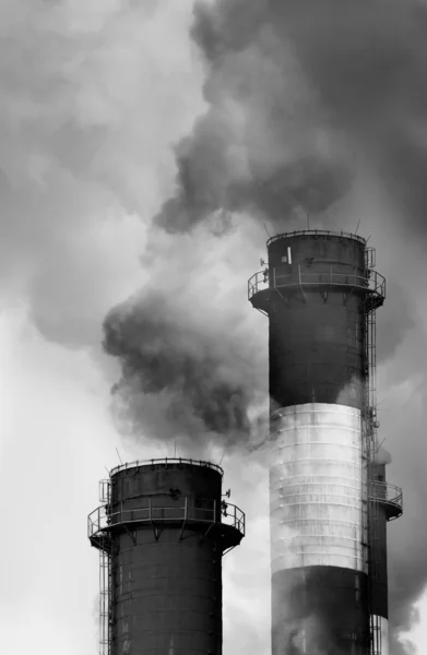Industrial chimneys releasing toxic smog clouds to atmosphere