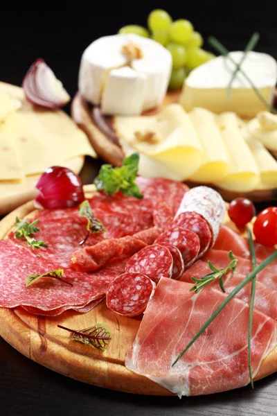 Salami and cheese platter with herbs