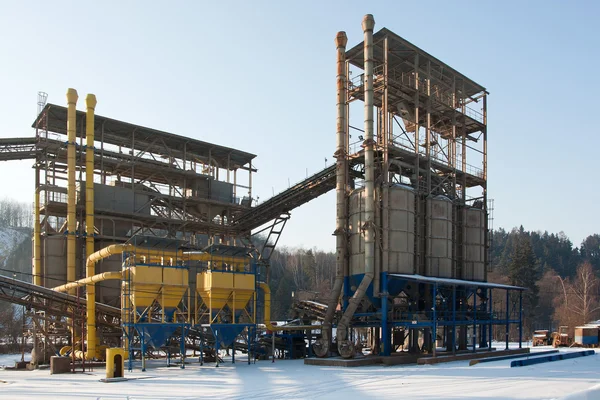 Stone quarry with silos, conveyor belts in winter
