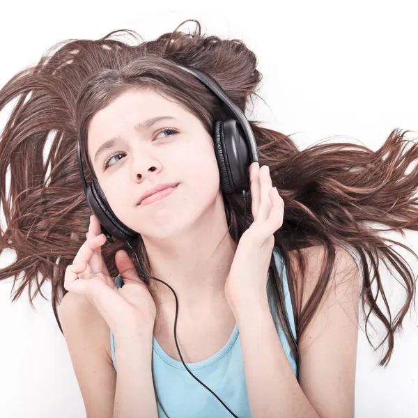 Nice teen girl listening to music by Stock Photo