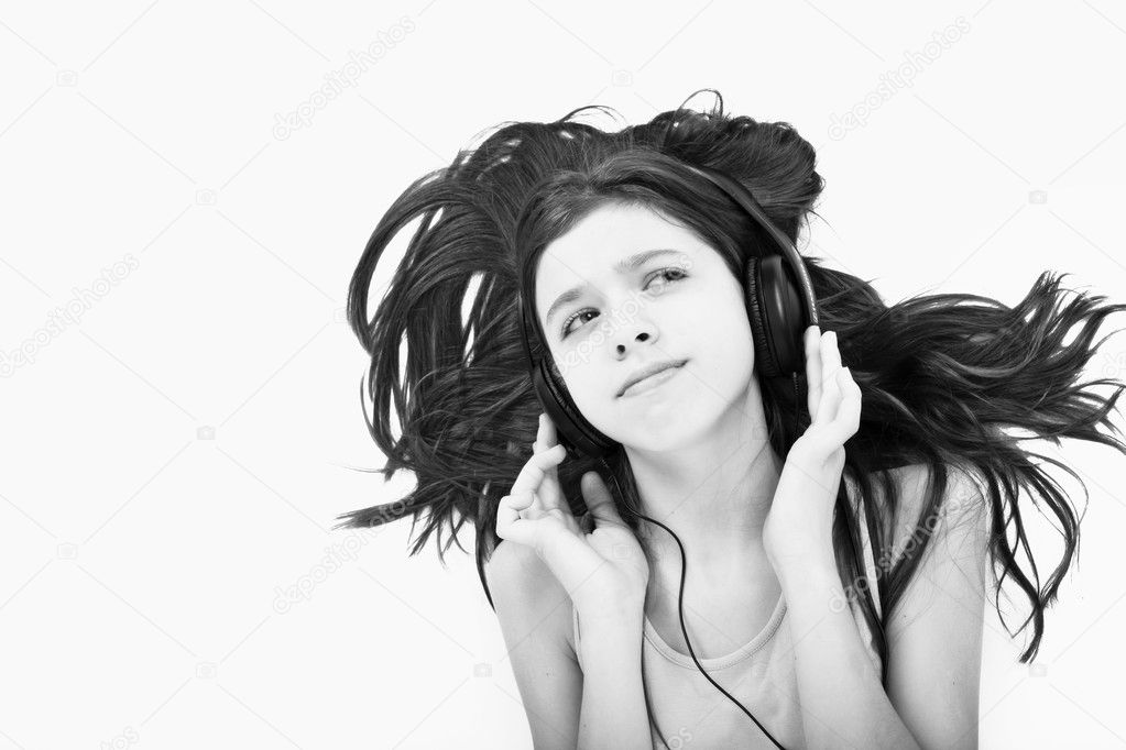 Nice teen girl lying on floor listening to music