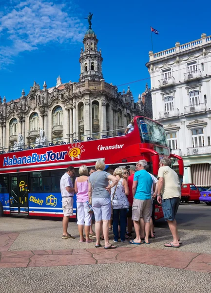 Tourists boarding a sightseeing bus in Havana