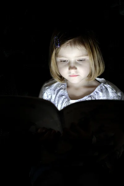 litte girl reading at night — Stock Photo #8423501