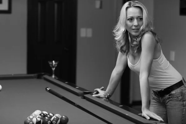 Woman leaning on a pool table