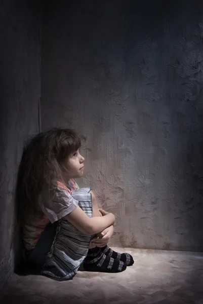 Child in a dark corner