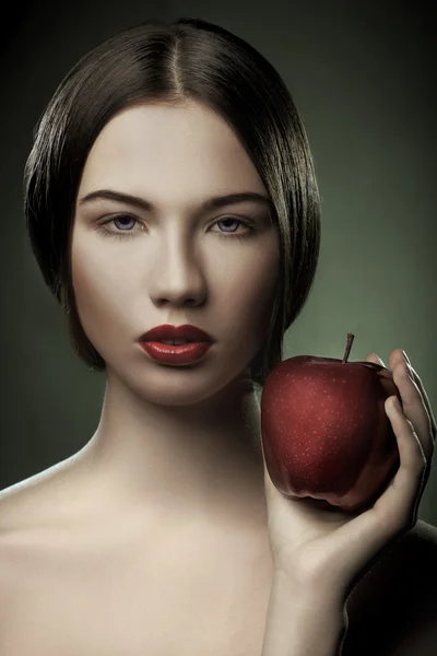 Portrait of caucasian young woman with apple