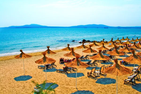 Straw umbrellas on peaceful beach in Bulgaria