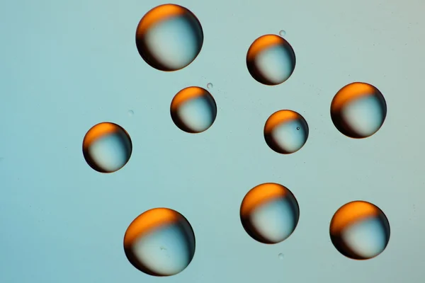 Blue drops with orange reflection