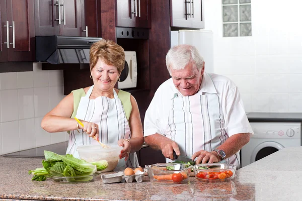 Elderly couple cooking