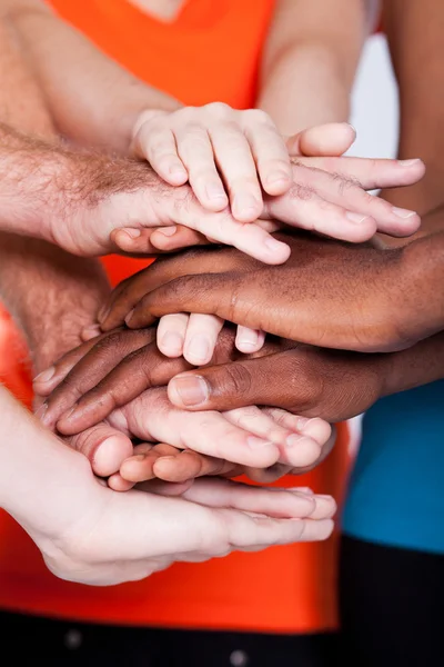Multiracial group hands together
