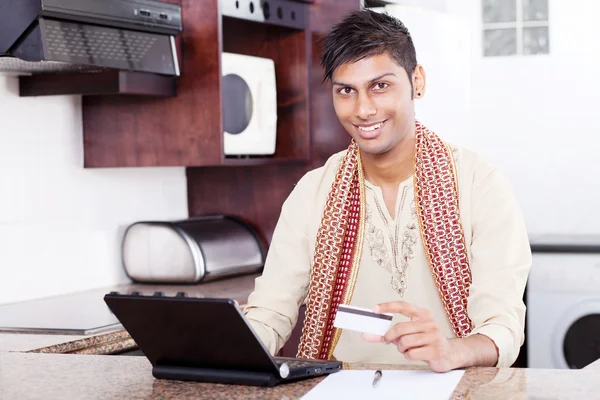 Young indian man with credit card