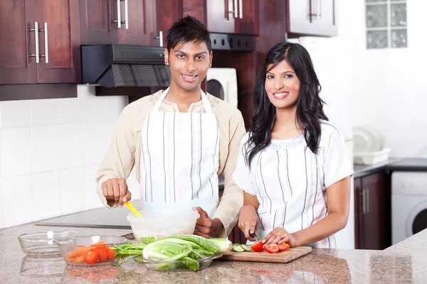 Young indian couple cooking