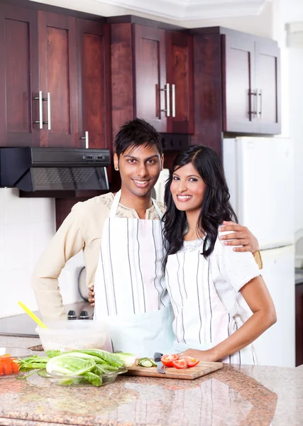 Happy young indian couple in kitchen