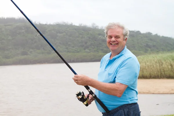 Happy senior man fishing
