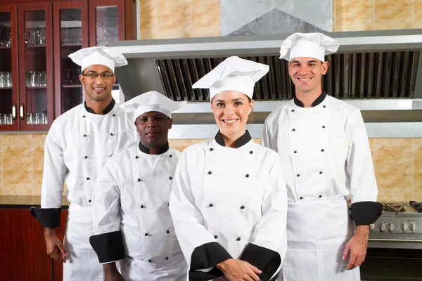 Group of professional chefs in hotel kitchen