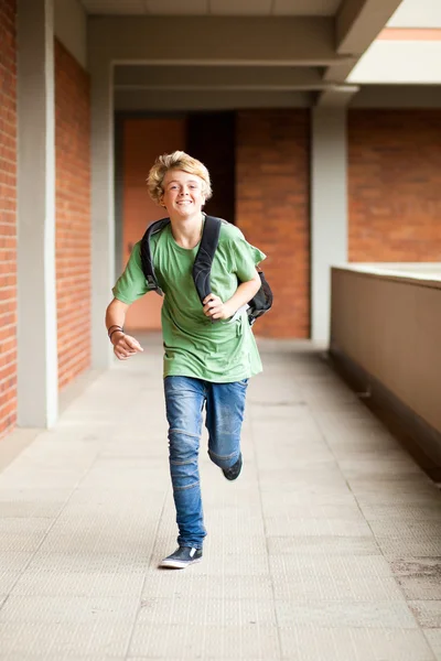Middle school student running in school passage