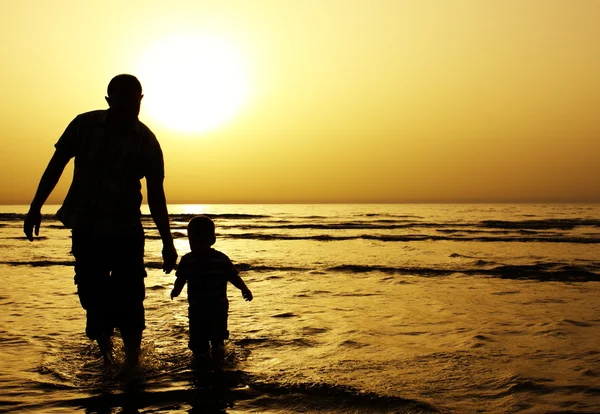 Child with his father at sea.