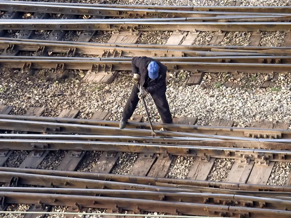 Maintenance worker fixing railway bolts