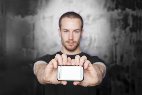 Mobile phone display in focus! Man holding device with fingers