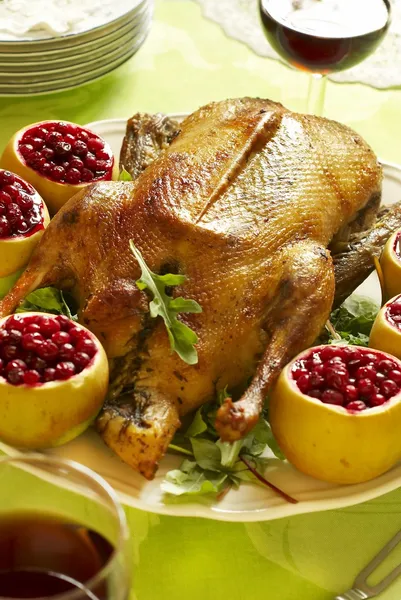 Christmas roast goose with apples stuffed with cranberries