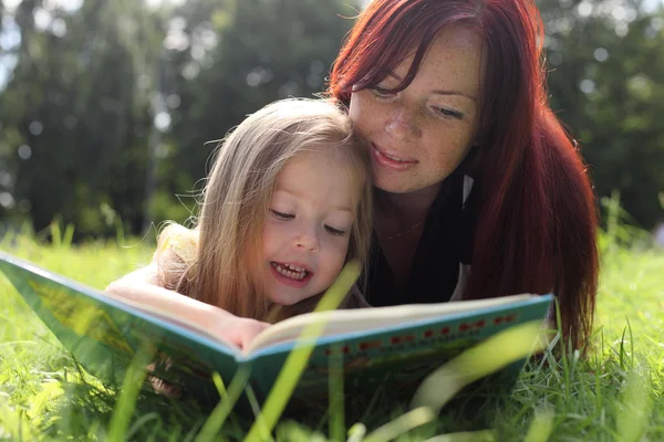 Mother and baby girl reading book