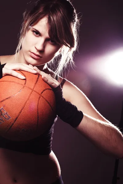 Female basketball player holding ball