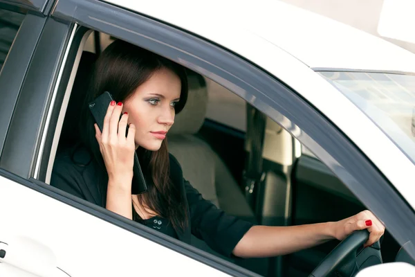 Woman in car calling by phone