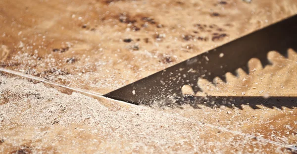 Close-up of a saw cutting wood furniture