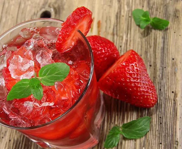 Fresh strawberry drink on wood background