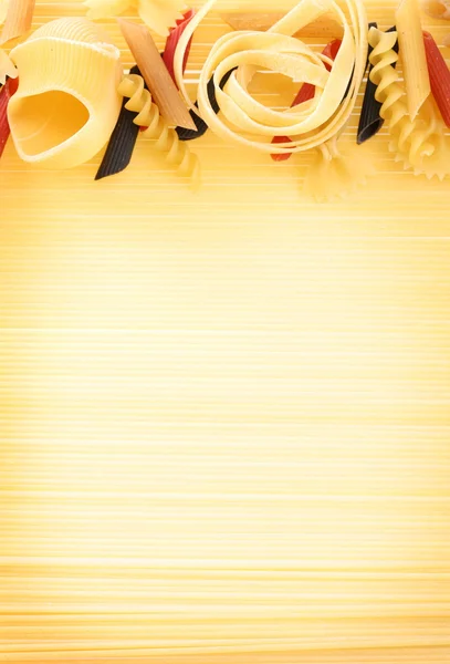 Uncooked pasta as a background.