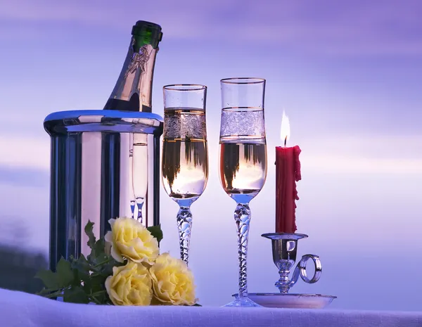 Art romantic view with champagne and candles burning in the sky