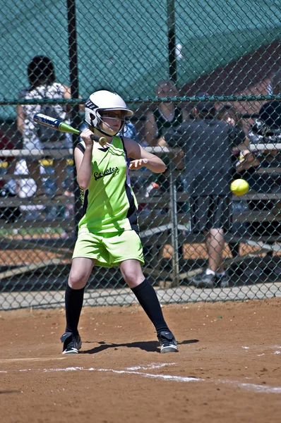 Young Girl Making a Hit During Softball Game