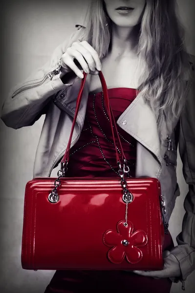 Fashion shot of red patent leather bag