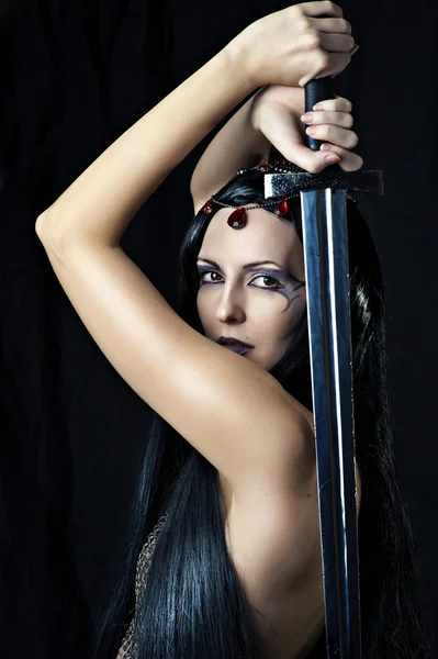 Young sexy woman warrior holding sword