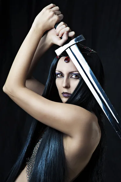 Young sexy woman warrior with sword