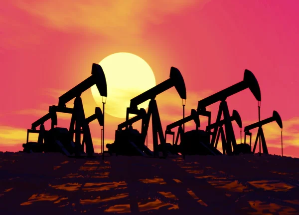 Oil well silhouetted against deep red evening sunset