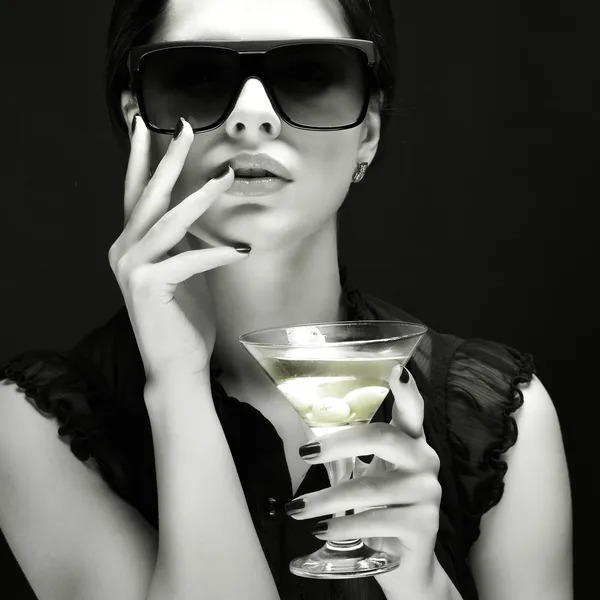 Beautiful young girl with glass of martini