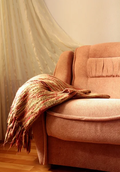 Interior of the sofa with a blanket