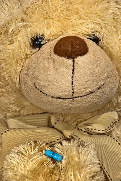 Cute sick teddy bear with a solution — Stock Photo #9608680