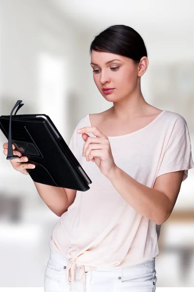 Portrait of young pretty woman holding tablet computer