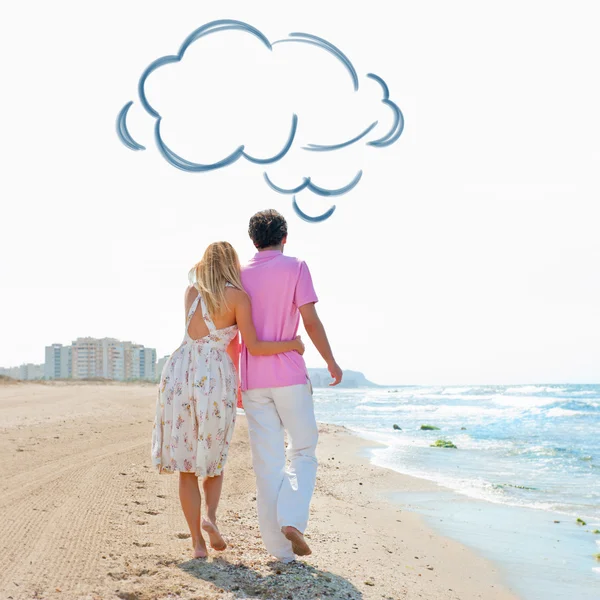 Couple at the beach holding hands and walking. Sunny day, bright colors. Europe, Spain, Costa Blanca. Blank cloud balloon overhead