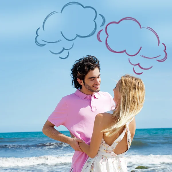 Young couple at beach, embracing, side view. Natural emotions. Happy life. Blank cloud balloons for their thoughts overhead