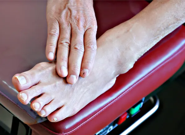 Senior patient foot on examination bench