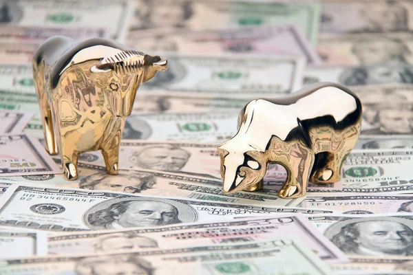 Dollar currency notes with bull and bear — Stock Photo #10428223
